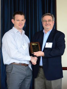 Russ Peterson (left) is presented with the TMS Service Award by Darrell McMillian (right).