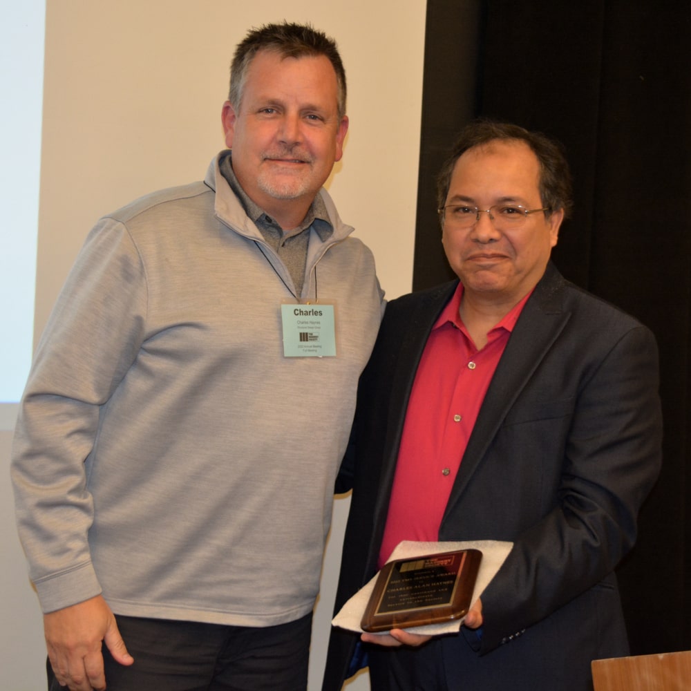 Charles Haynes (left) receives a 2022 Service Award from Mohamed ElGawdy